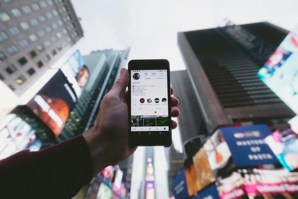 man holding a phone with his social media app