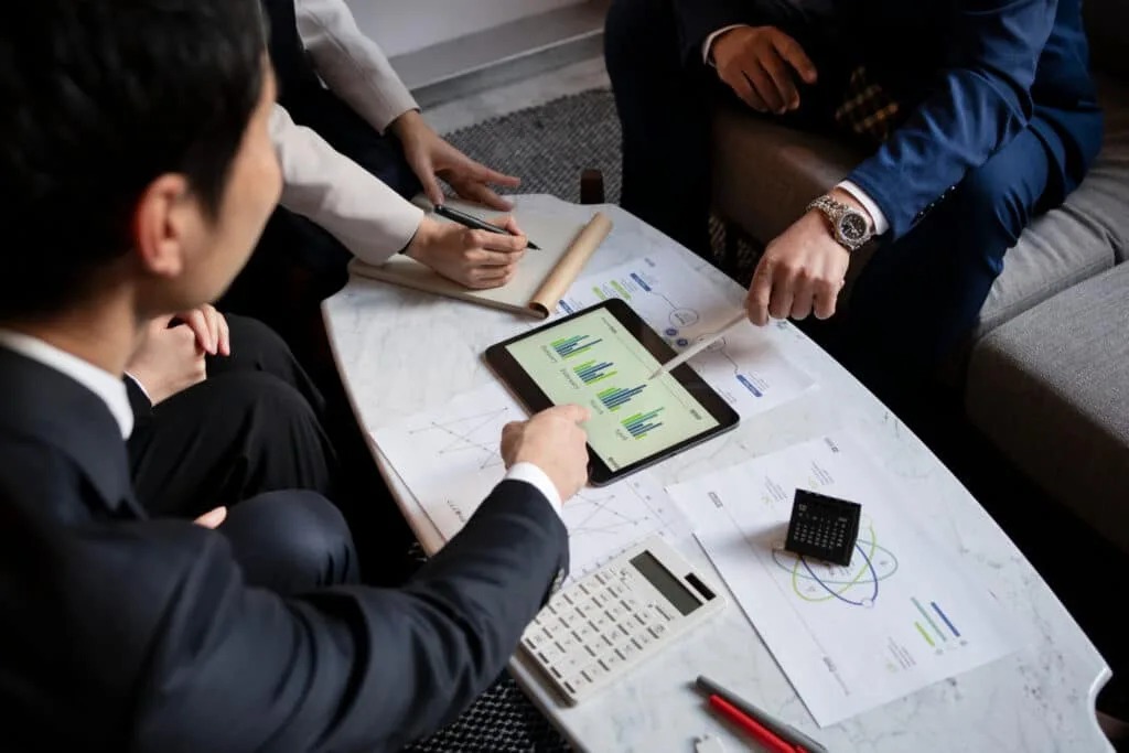three businessman checking business stats