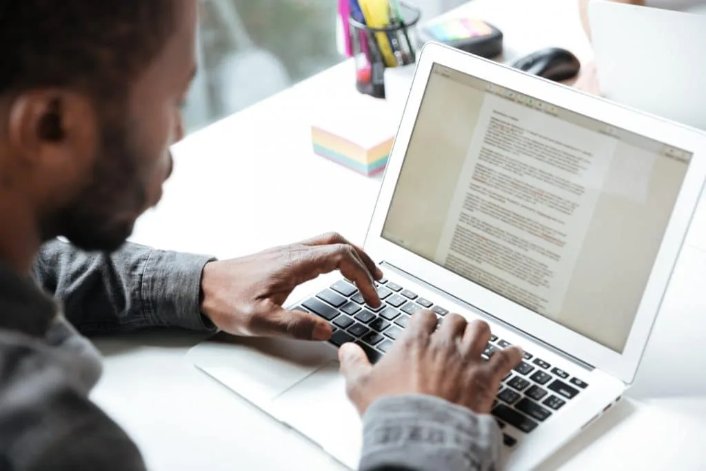 a man creating an email on his laptop
