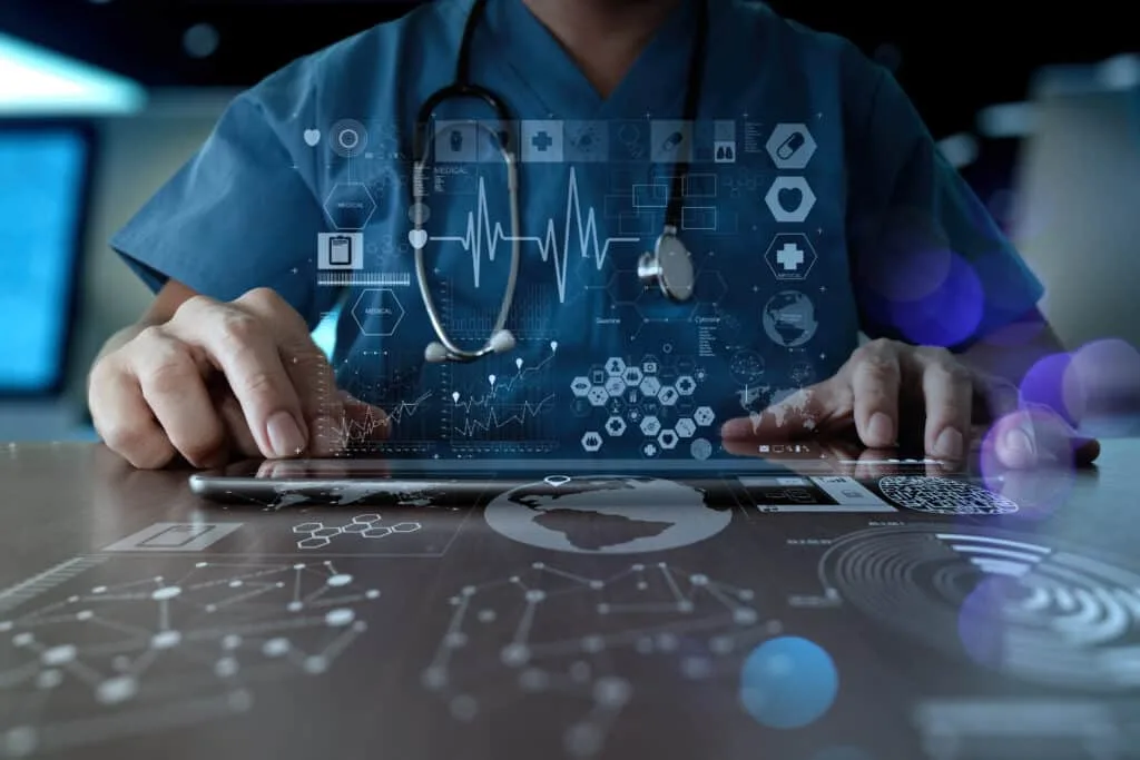 Digital Health Product concept. Man working on his laptop with digital icons displayed.