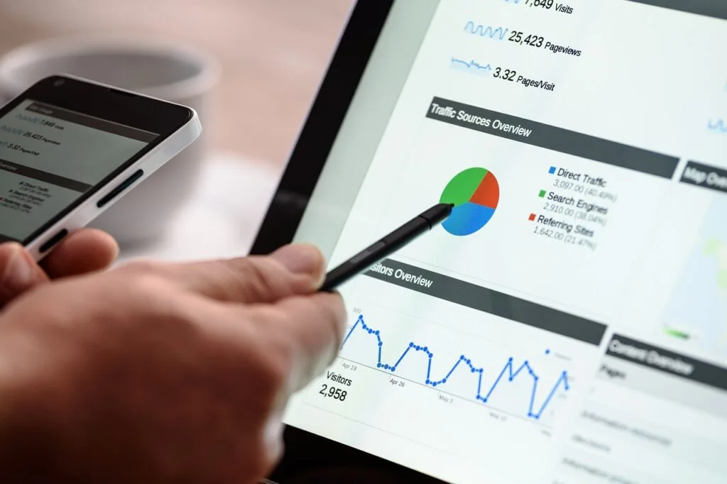 pointing a pen to a graph on computer screen