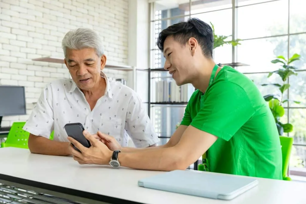 two man looking at a mobile phone